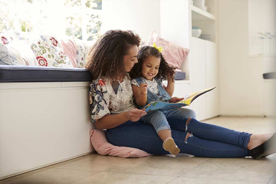 Mother reading book to her daughter
